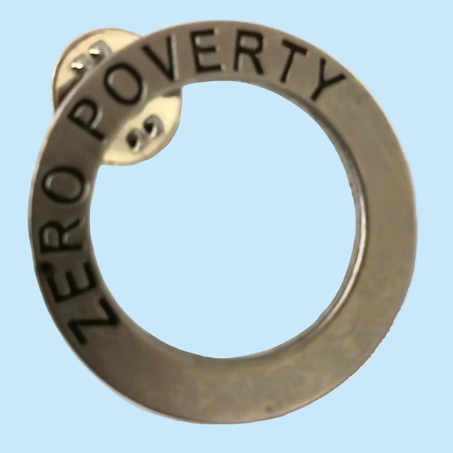 Zero poverty metal circular badge